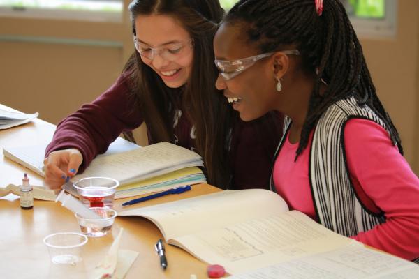 two middle school girls at a desk Thumbnail